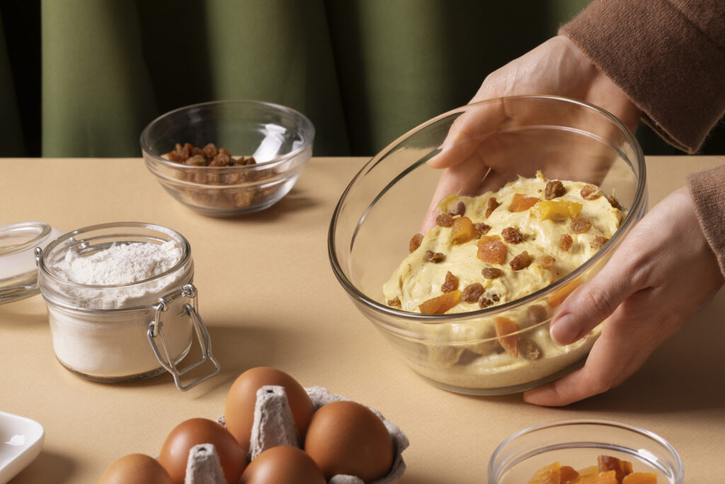 A selection of Betty Crocker dishes, including fluffy pancakes, chicken pot pie, fudge brownies, and fresh salad, displayed on a wooden table.