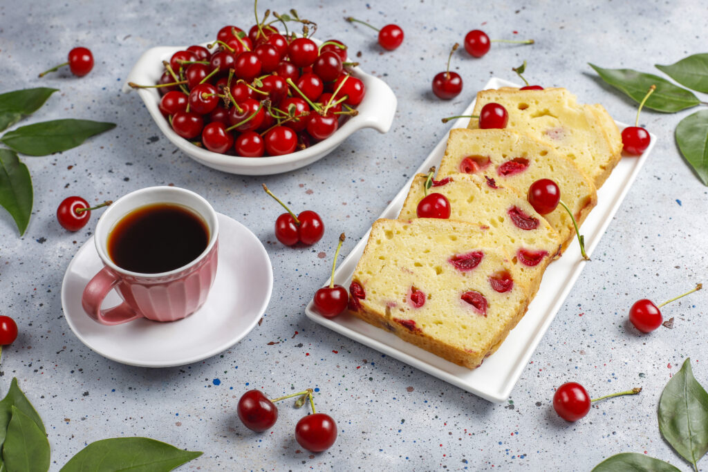 A perfectly baked cherry cheesecake with a golden graham cracker crust, creamy filling, and vibrant cherry topping.