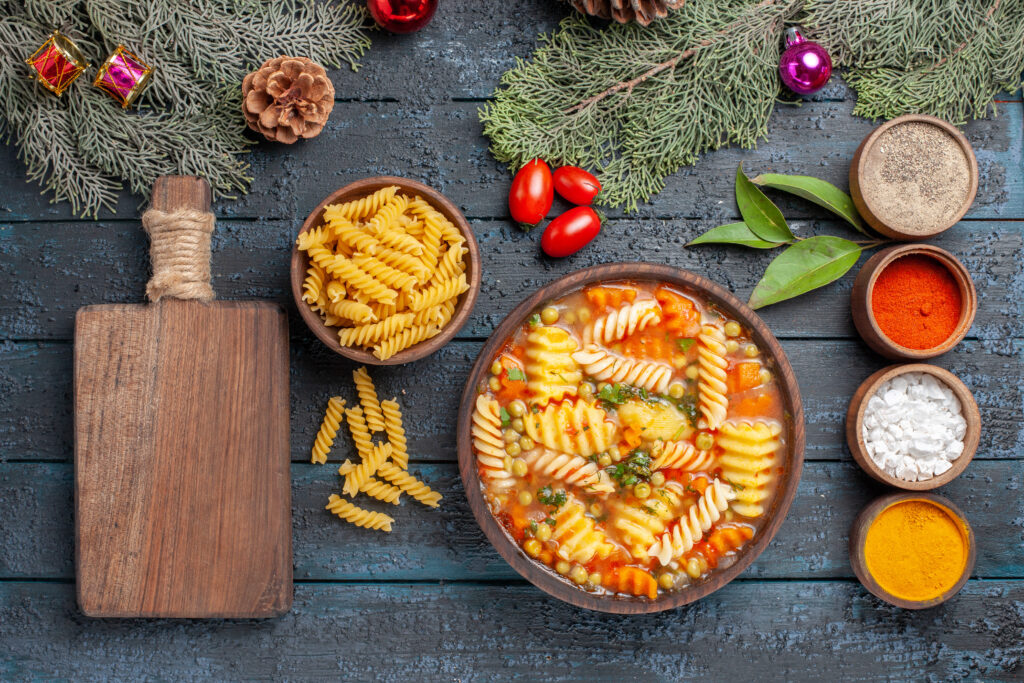 A bowl of ditalini pasta topped with a rich tomato sauce, vegetables, and beans, garnished with fresh parsley and served in a rustic setting.